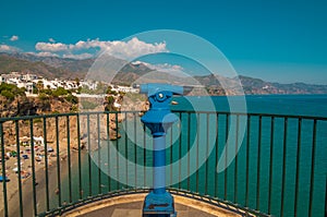 View from a tourist observation telescope with the beautiful beach of Nerja in the background photo