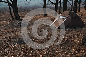 View of a tourist tent with a quick-build system, brown. no people. place for text. Dull dark tones of autumn morning, winter