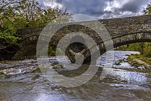 A view toward the bridge over the river Teifi at Cenarth, Wales after heavy rainfall