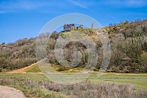 A view towards the castle ruins at the Three Cliffs Bay, Gower Peninsula, Swansea, South Wales