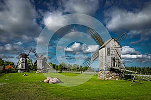 View towards Collection of old windmills at Angla Windmill Hill on a sunny day with blue sky and clouds in Saaremaa photo