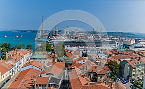 A view towards the cruise terminal from the clock tower above Tito Square over the rooftops of Koper, Slovenia