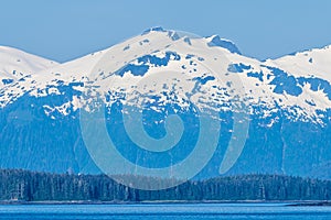 A view towards the forested shoreline of the Gastineau Channel approaching Juneau, Alaska photo