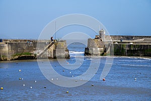 A view towards the harbour entrance at low tide in Saundersfoot, Wales
