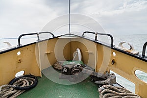 View towards the prow of a motor ship sailing the estuary of the Thames in Englang, UK, with the sea and the horizon in the