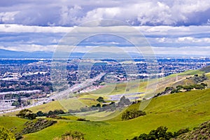 View towards San Jose and the bayshore freeway; green hills in the foreground; south San Jose, San Francisco bay area, California photo