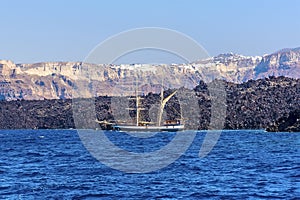 A view towards the volcanic island of Nea Kameni, Santorini with the caldera rim in the background