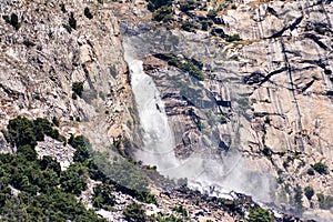 View towards Wapama falls dropping along granite walls; Hetch Hetchy Reservoir area, Yosemite National Park, Sierra Nevada