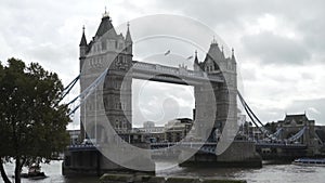 View of the Tower Bridge and traffic above the Thames against the cloudy sky in summer day in the center of London