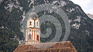 view on the tower of the catholic church saint peter and paul in mittenwald