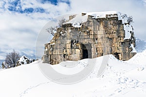 Tower of Caudius covered in snow during winter, Faqra Roman ruins, Lebanon photo