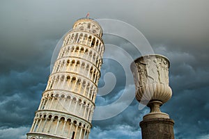 View of the tower of Pisa from below and dramatic cloud sky