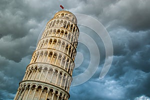 View of the tower of Pisa from below and dramatic cloud sky