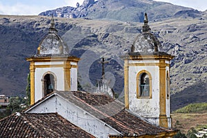 View of towers of historic baroque church Igreja Nossa Senhora das Merces e Perdoes, and mountains, Ouro Preto, Minas Gerais, photo