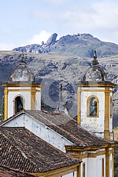 View of towers of historic baroque church Igreja Nossa Senhora das Merces e Perdoes, and mountains, Ouro Preto, Minas Gerais, photo