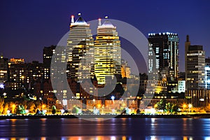 View of the towers, skyscrapers and buildings in Dnepr city at night, lights reflected on the river Dnieper, Ukraine.