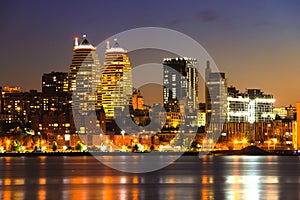 View of the towers, skyscrapers and buildings in Dnepr city at night, lights reflected on the river Dnieper, Ukraine.