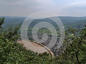 View of town Bremm, Germany, located on the hills of Moselle river, with dirty road and flooded promenade.