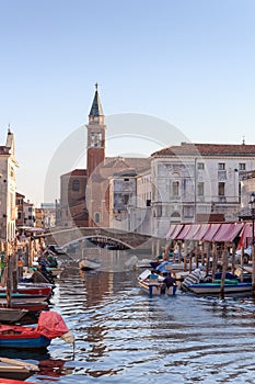 View of town Chioggia with canal Vena and church steeple of Chiesa della Santissima Trinita in Veneto, Italy