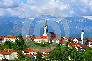 View of the town of Kranj with clouds covered mountain peak behind photo