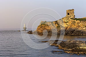 View of the town lighthouse Tourlitis, fortress and the sea Greece, island Andros, Cyclades