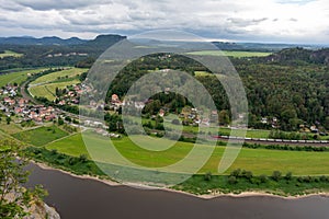A view of a town and a river with a train passing by