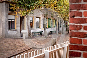 View on traditional Dutch houses and streets in a recreated heritage museum with beautiful historic vintage scenes from Holland.