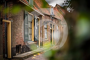View on traditional Dutch houses and streets in a recreated heritage museum with beautiful historic vintage scenes from Holland.