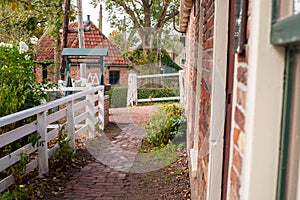 View on traditional Dutch houses and streets in a recreated heritage museum with beautiful historic vintage scenes from Holland.