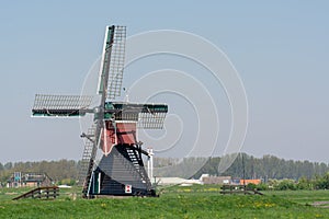 View on traditional Dutch wind mill, spring landscape in North Holland