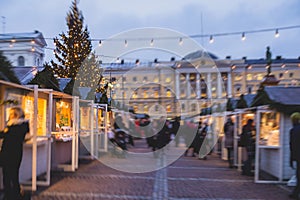 View of traditional famous annual Christmas Market in Senate Square of Helsinki, Finland, with kiosks, decoration, gifts and