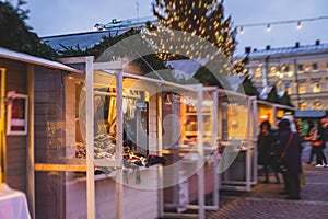 View of traditional famous annual Christmas Market in Senate Square of Helsinki, Finland, with kiosks, decoration, gifts and