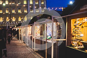 View of traditional famous annual Christmas Market in Senate Square of Helsinki, Finland, with kiosks, decoration, gifts and