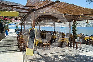 View of a traditional Greek taverna at the seaside on the charming Greek island of Telendos.