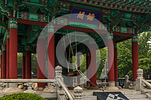 View on traditional korean Bell Pavilion with cloche and equipment in the Yongdusan Park. Busan, South Korea, Asia