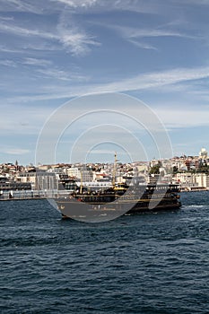 View of a traditional tour boat on Bosphorus in Istanbul. European side is in the view.