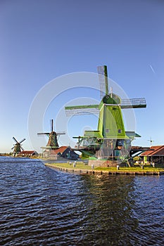 View of Traditional Wooden Dutch Windmills at the Zaan River in Zaanse Schans