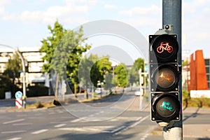 View of traffic light for bikes near road in city. Space for text