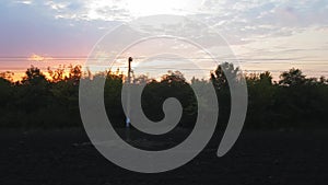 The view from the train on the beautiful scenery with hills and forest after sunrise. The view from the window of the