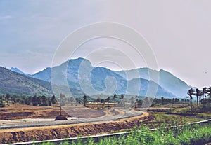 View from a train of hills and road