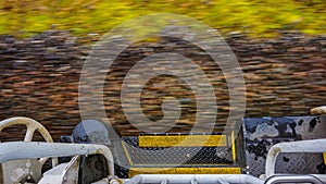 View of train track from the boarding platform of a speeding locomotive