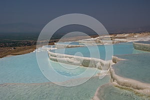 View of travertine hot springs in Pamukkale, Turkey, selective focus