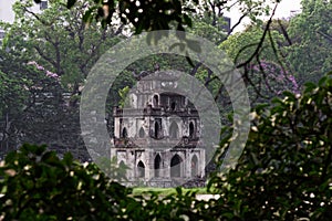 View through the tree branches on Turtle Tower in Hanoi, Vietnam