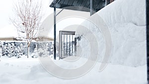 View of the trees, bushes, gazibo on backyard in heavy snowfall with blizzard