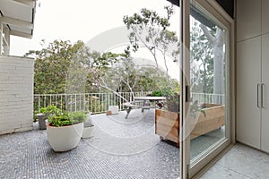View of treetops from large terrace in Australian luxury home