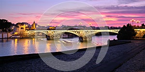 View Of Triana Bridge In Seville Spain At Sunset