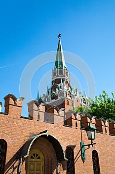 View of the Trinity tower of the Moscow Kremlin with a fortress wall on a Sunny spring day