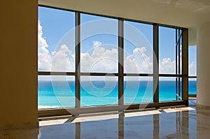 View of tropical beach through hotel windows