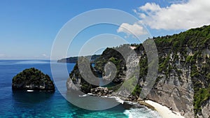 View of tropical beach, sea rocks and turquoise ocean, blue sky. Atuh beach, Nusa Penida island, Bali, Indonesia