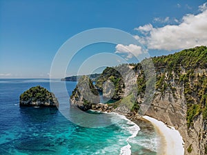 View of tropical beach, sea rocks and turquoise ocean, blue sky. Atuh beach, Nusa Penida island, Bali, Indonesia. Tropical